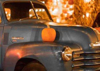 Truck with pumpkins on top and lights around it
