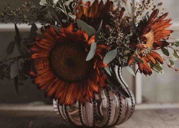 Fall bouquet with orange flowers and pewter vase