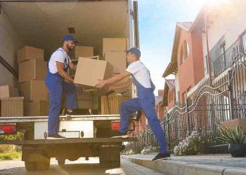 Movers taking boxes out of a large moving truck