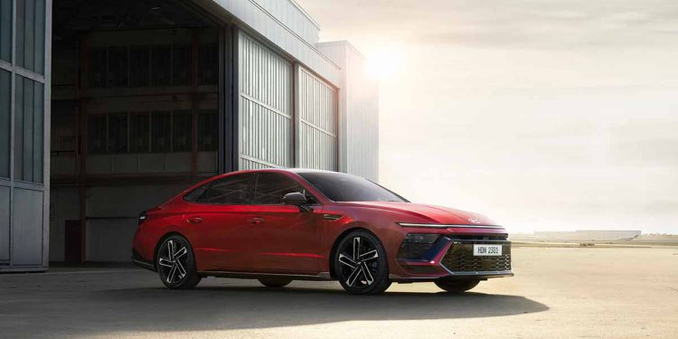 Red car pulling out of storage garage under a hot sun