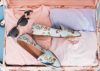 Suitcase with pink and purple pastel clothing