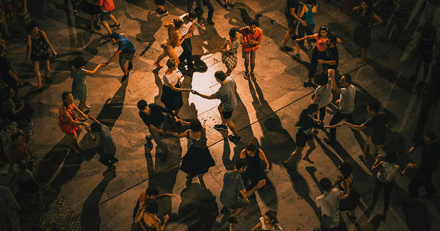 People dancing in the street at night