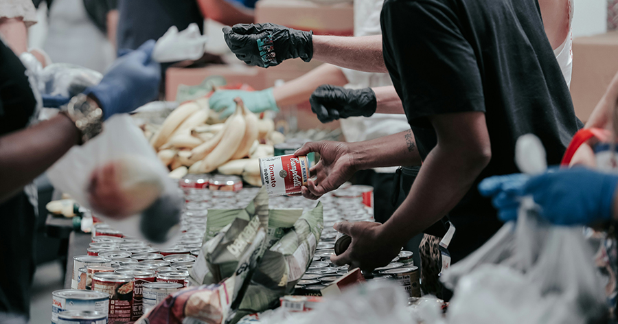 Volunteers handing out canned goods.