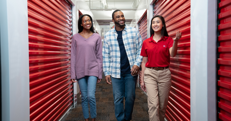 Man and woman being shown around storage unit
