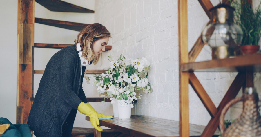 Person cleaning furniture to prepare it for storage.