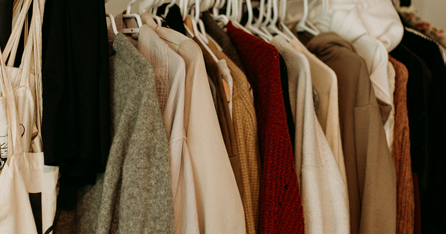 Clothing on hangers on a storage rack.
