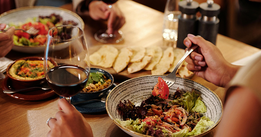 a dinner table with food and wine