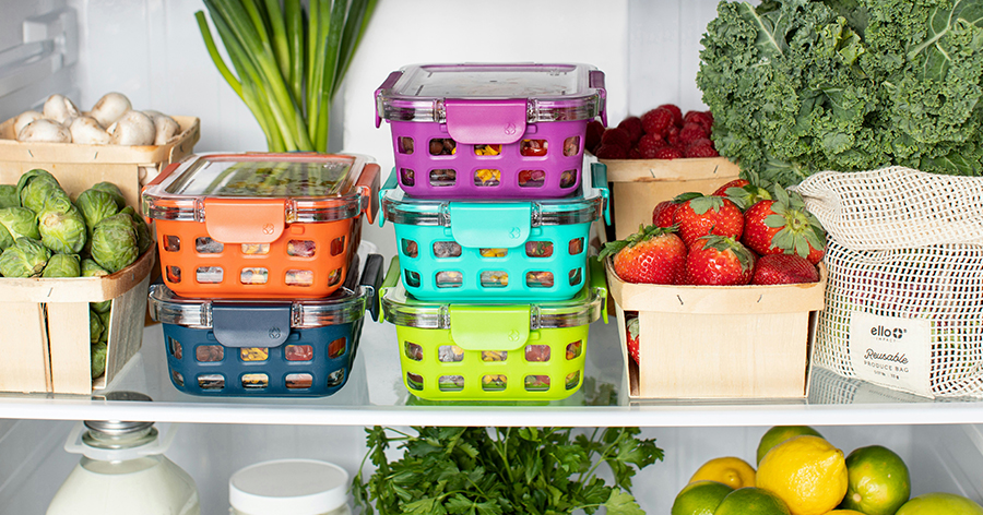 Colorful plastic containers stacked in a fridge.