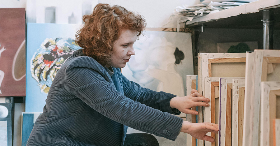 Woman looking through paintings