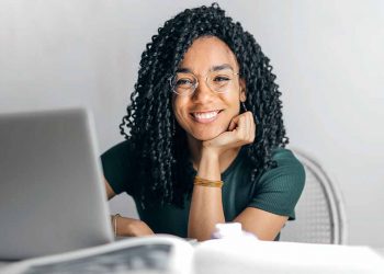 Woman smiling at laptop