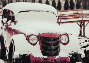 Vintage car covered in snow