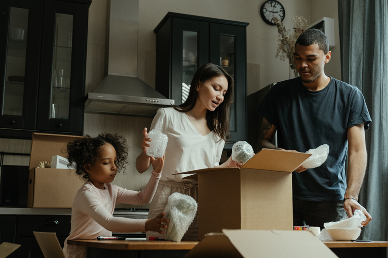 Family packing up kitchen items