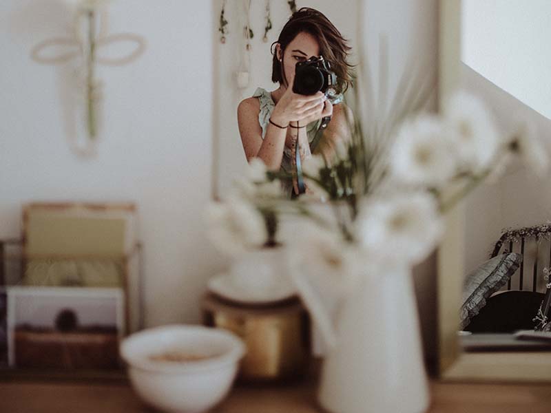 Woman taking photos in an apartment