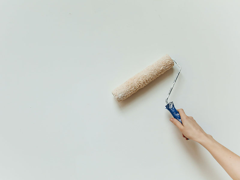 Hand holding a paint roller