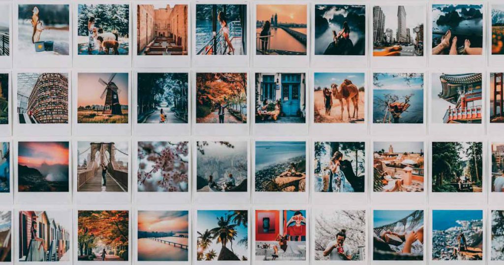 A white wall covered in Polaroid pictures depicting special moments in an engaged couple’s life, used as decoration for a small bridal shower.
