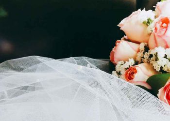 Floral wedding bouquet and white veil