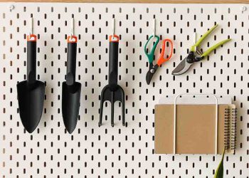 Gardening tools hung on a pegboard