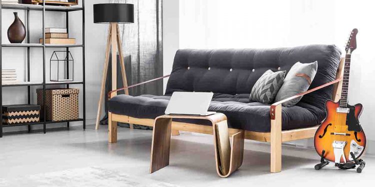 Gray room with couch, guitar, and laptop shown