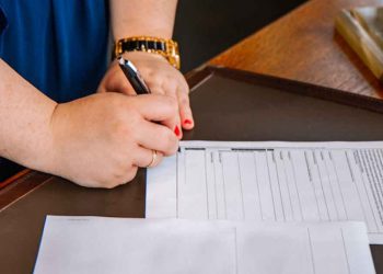 Person signing documents.