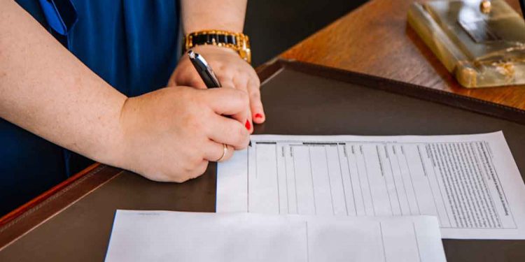 Person signing documents.