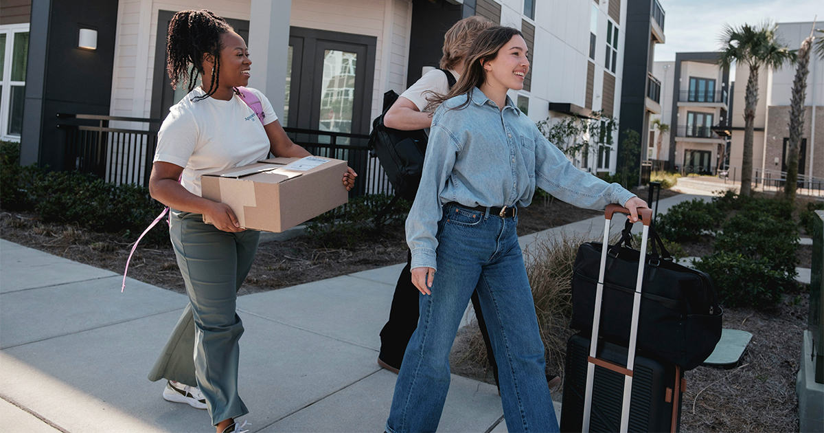Young people moving with boxes and suitcases
