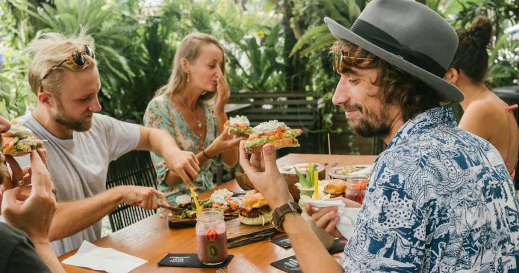 A group of friends enjoys a delicious al fresco brunch on a sunny day at one of the best restaurants in Fort Lauderdale.