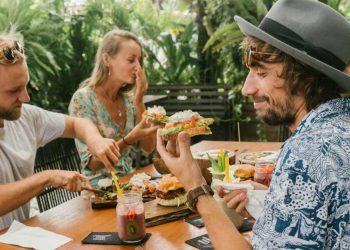 A group of friends enjoys a delicious al fresco brunch on a sunny day at one of the best restaurants in Fort Lauderdale.
