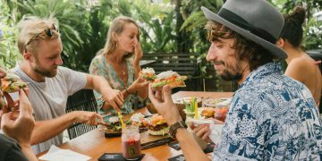 A group of friends enjoys a delicious al fresco brunch on a sunny day at one of the best restaurants in Fort Lauderdale.