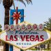The iconic and colorful “WELCOME TO FABULOUS LAS VEGAS NEVADA” sign surrounded by palm trees on a sunny day.