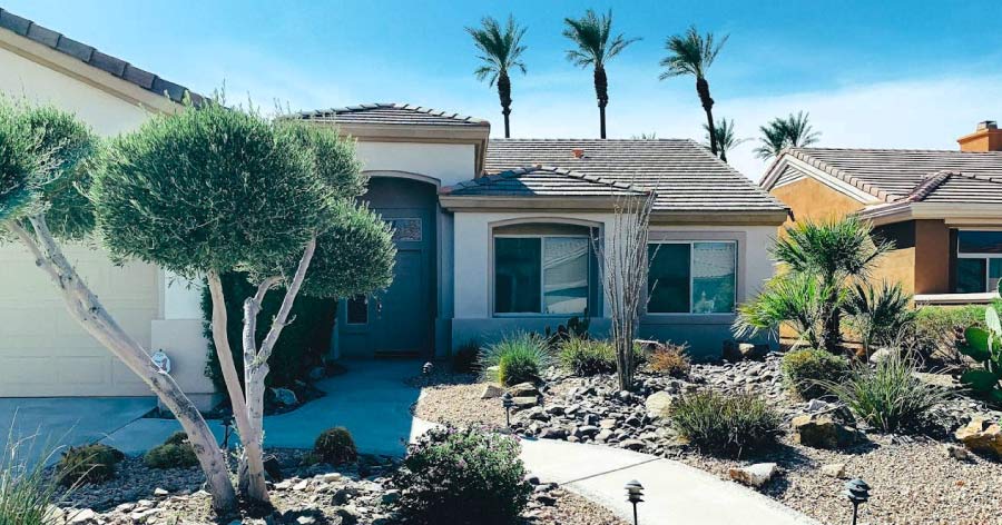 A one-story, stucco home, featuring desert landscaping and a tile roof, in one of the best neighborhoods in Las Vegas.