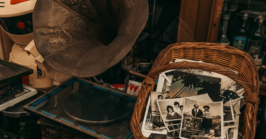 A phonograph and old photos in a storage unit