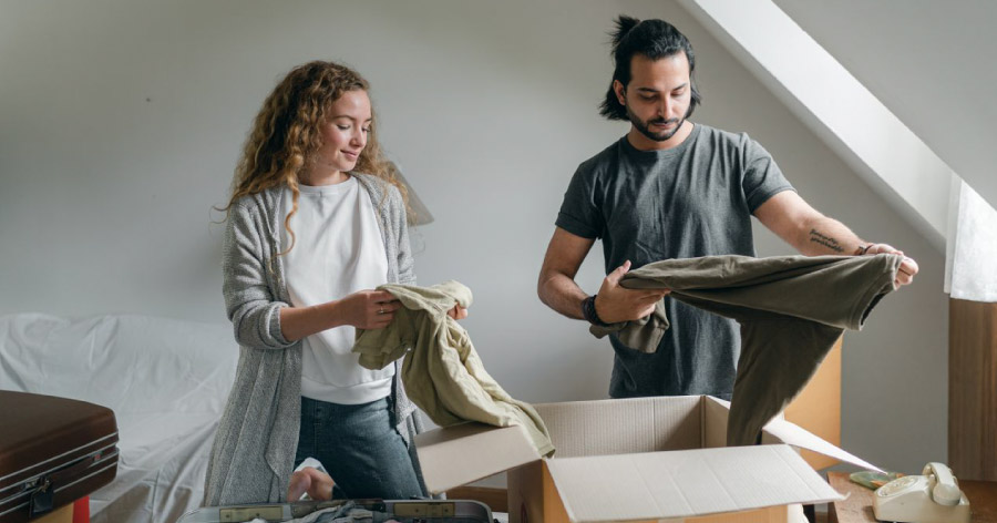 A couple is decluttering their wardrobe, deciding what to get rid of and what to put in temporary storage during home renovations.