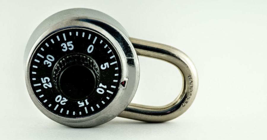 A small dial lock resting on its side against a white background.