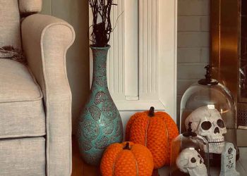 Pumpkins and fake skeletons on fireplace mantle