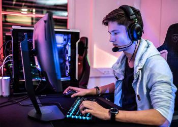 Young man playing a video game with a headset on