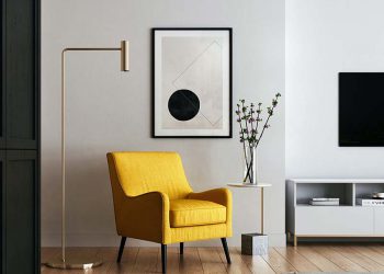 Designed space with yellow chair and black and white wall art