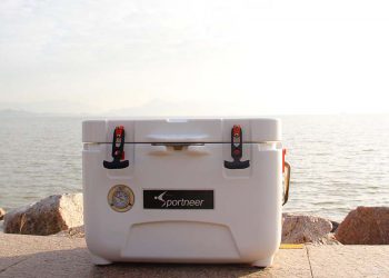 Cooler sitting on ground next to beach