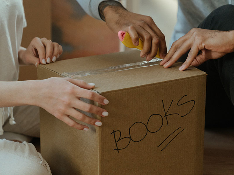 People opening a moving box.