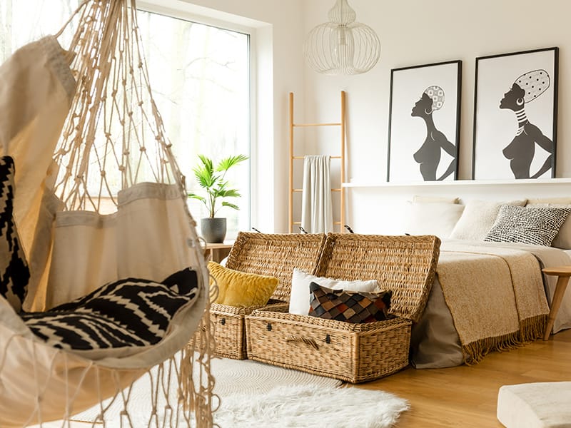 bedroom with rattan chest at foot of bed