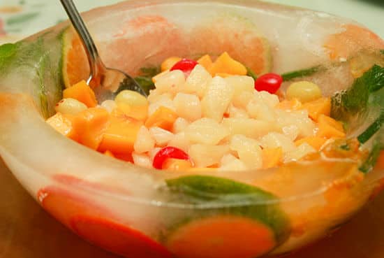 Bowl made of ice filled with fruit salad