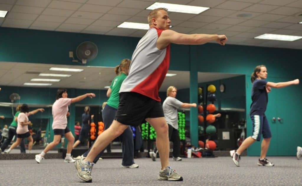 man leading a group in a fitness class