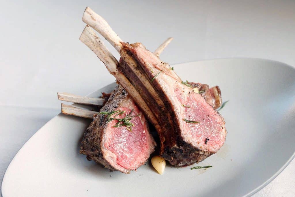 stacked lamb chops on a white plate from Maple & Ash in Chicago