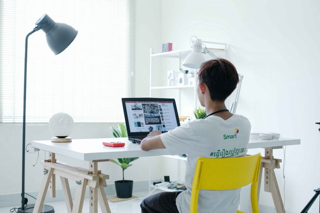 male student sitting at desk facing computer