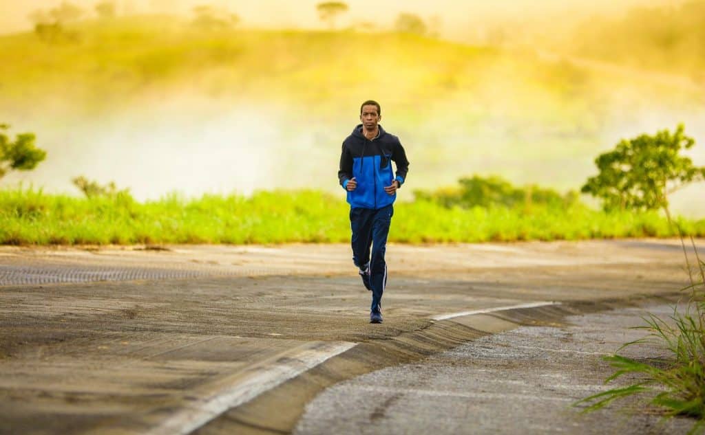 man running along a road by himself