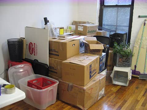 NYC living room filled with packed boxes