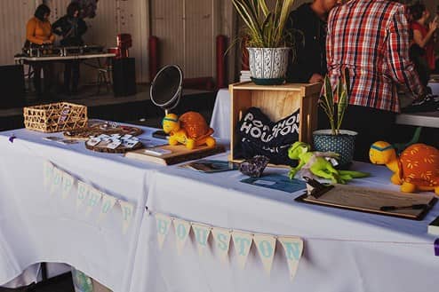 table filled with various items at the Pop Shop Houston