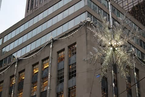 view of a giant snowflake in front of a building on fifth avenue in NYC