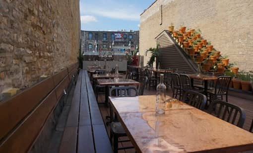 tables and seating areas outside at Taxim in Chicago