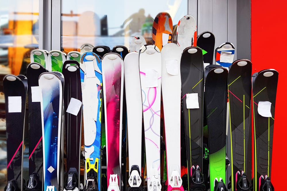 rental skis lined up outside shop