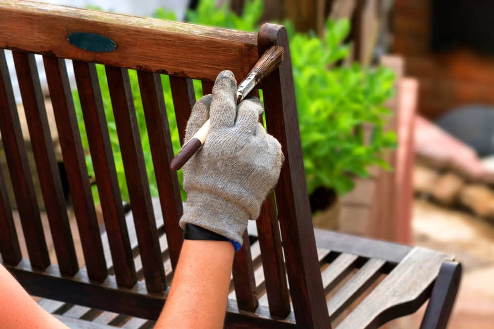 woman refurbishing a chair